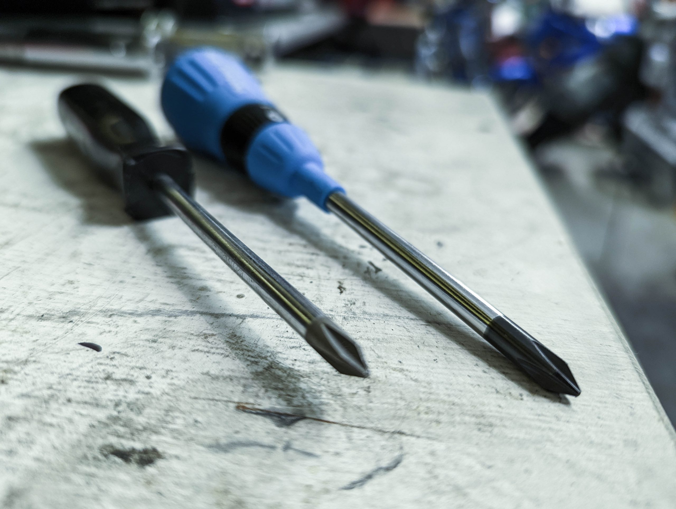 Phillips screwdriver next to a JIS screwdriver