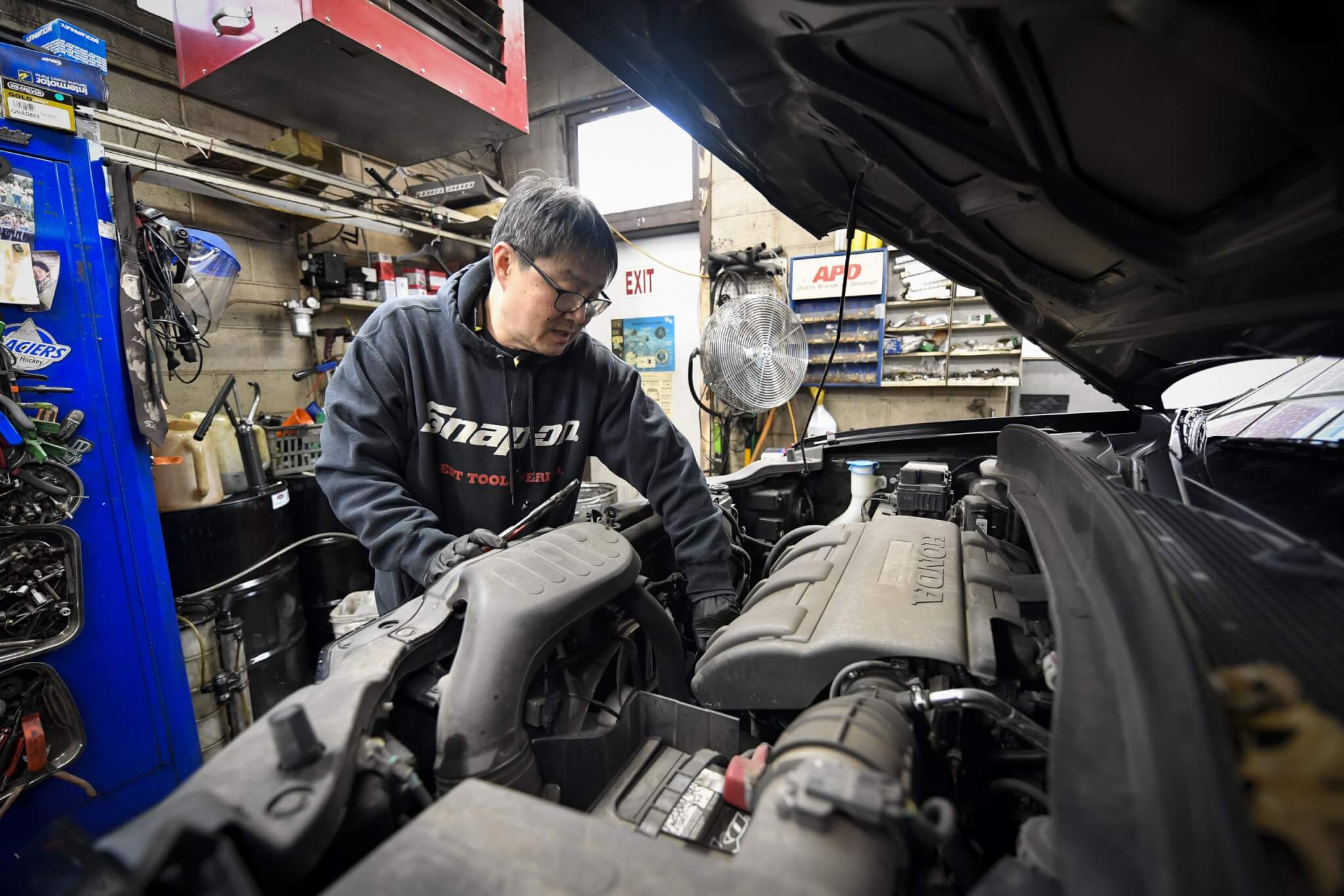 Tech repairing a Honda engine