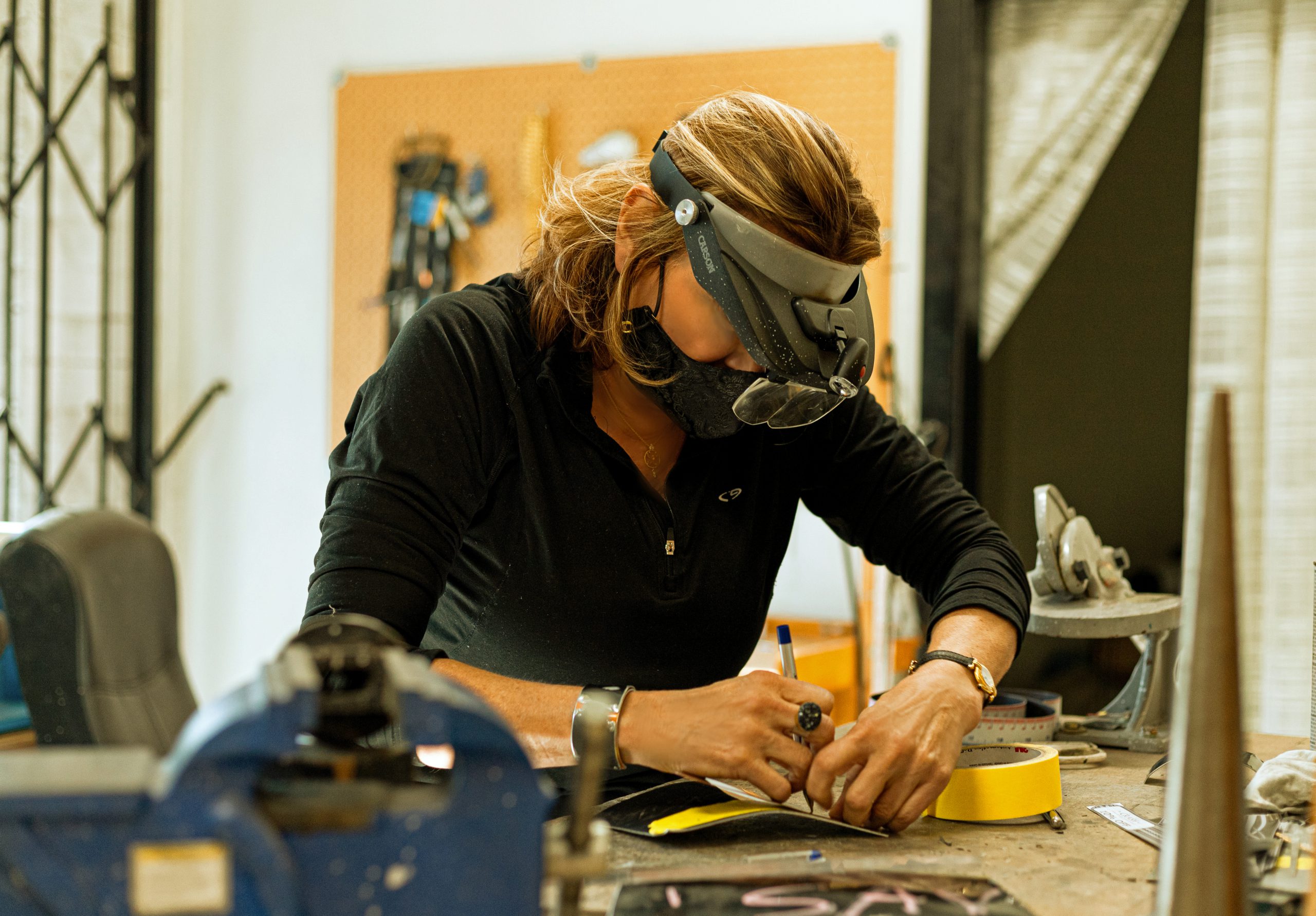 Photo of Christi Schimpke of Crash Jewelry working in her studio.