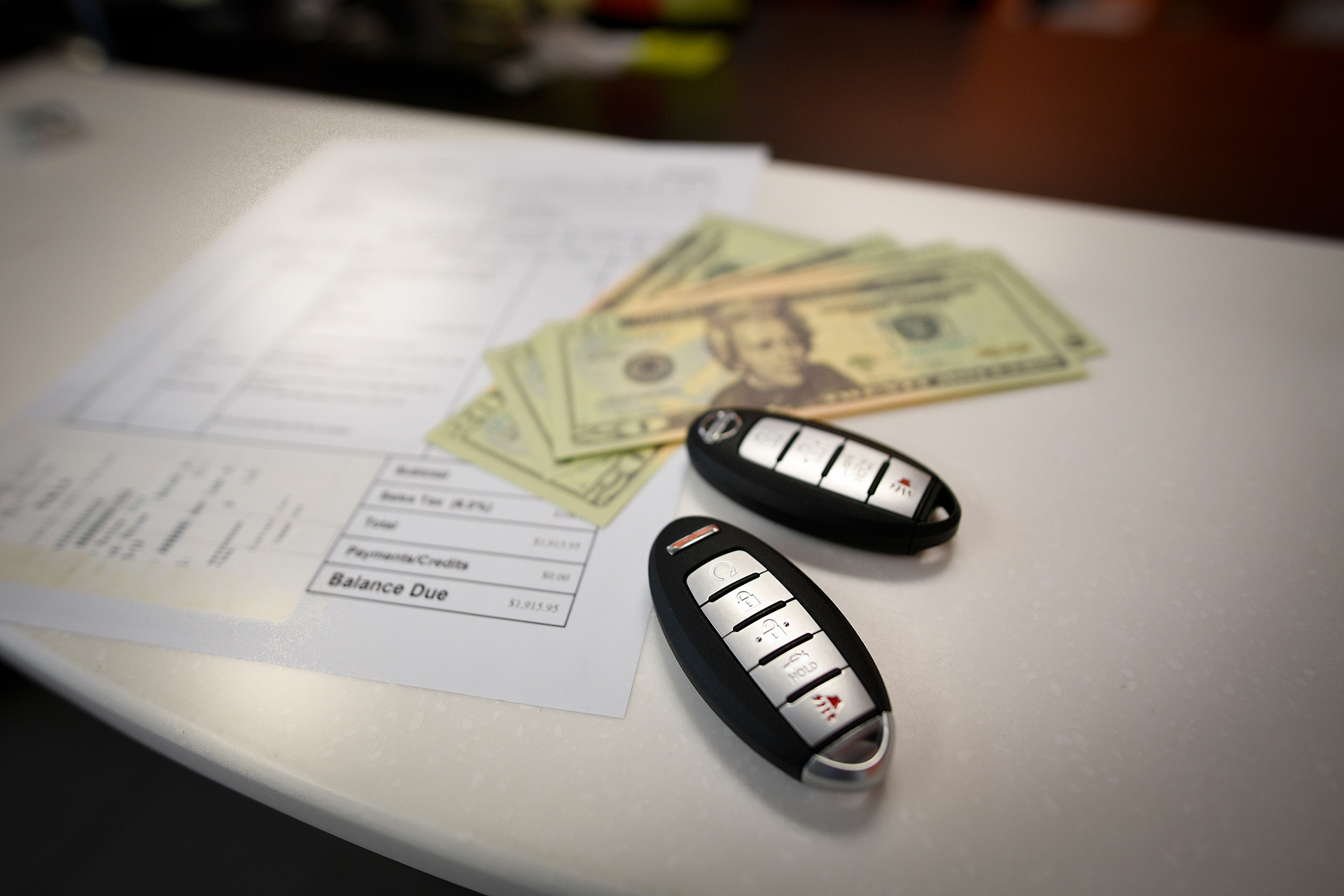 payment of a car bill with money on table