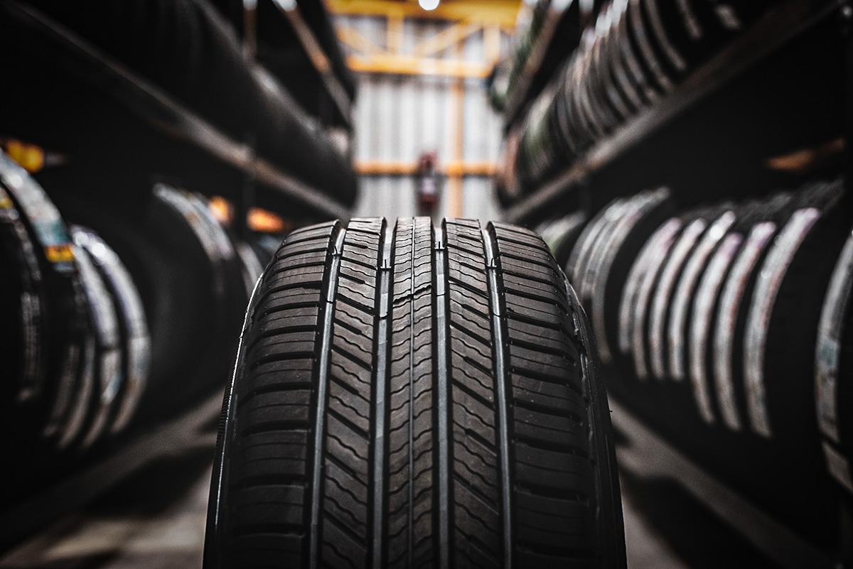 A new tire is placed on the tire storage rack in the car workshop.