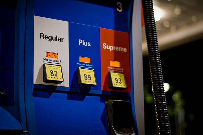 US gas pump with focus on regular fuel and price.